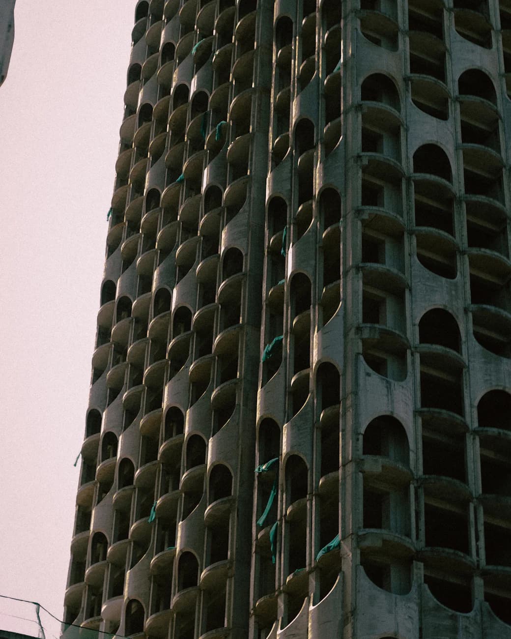 A concrete tower of arched openings under construction